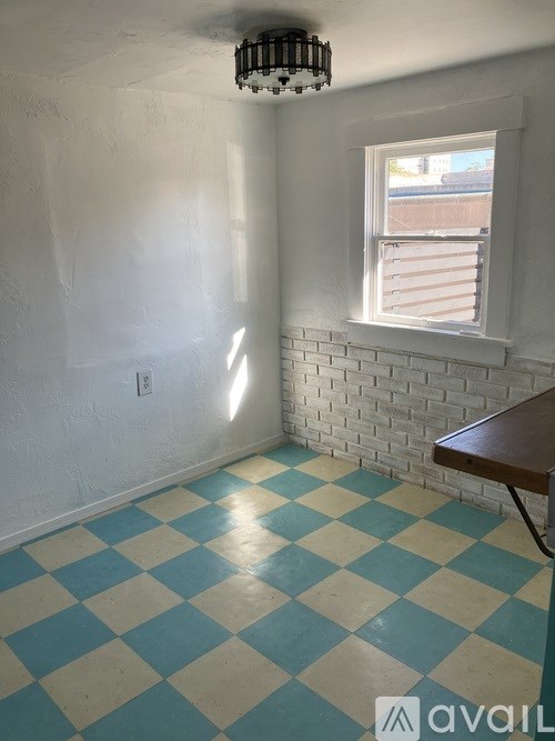 A room with a checkered floor and a window.
