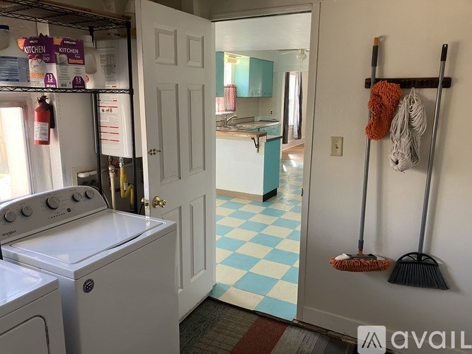 A kitchen with a white oven and a white door.