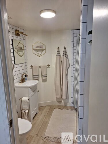 A room with wooden floors and a ceiling fan.