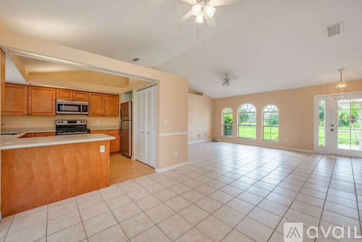 A spacious kitchen with wooden cabinets and a white countertop.