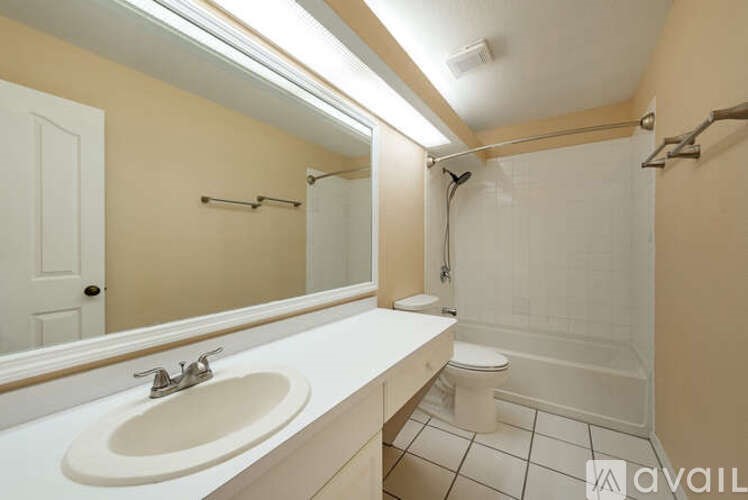 A bathroom with a sink, toilet, and shower.