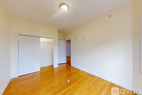 A room with wooden flooring and a window.