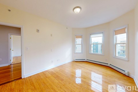 A thermostat showing 70 degrees on a beige wall.