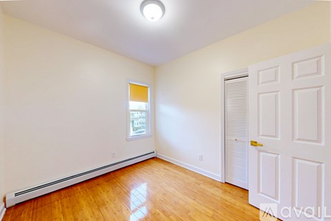 A room with wooden floors and a white door.