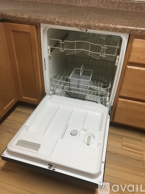 The image shows an open empty white refrigerator with its door open.