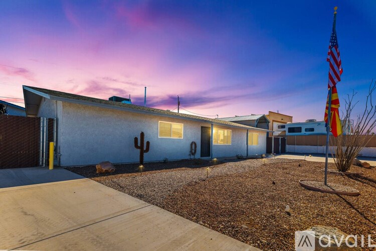 A house with a flag and a cactus in front.