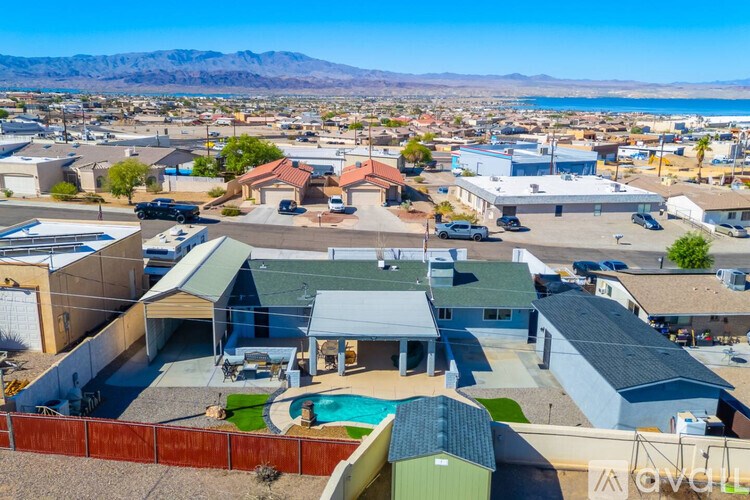 A bird's eye view of a neighborhood with houses and a pool.