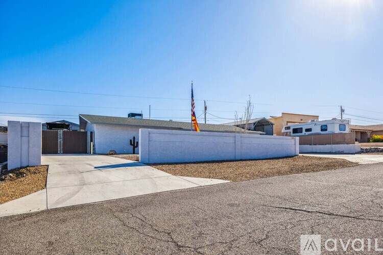A sunny day at a residential area with a house and a flag on a pole.
