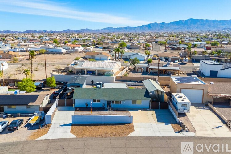A sunny day in a residential area with houses and a clear sky.