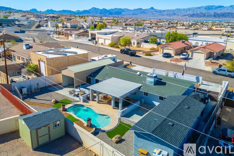 A bird's eye view of a neighborhood with houses and a pool.
