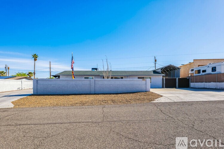 A building with a flag on top and a sign that says "available" in the foreground.