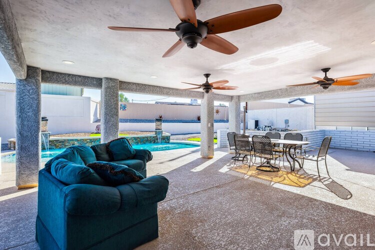 A living room with a blue couch and a table with chairs.