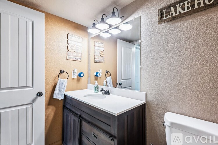 A bathroom with a white sink and a mirror above it.