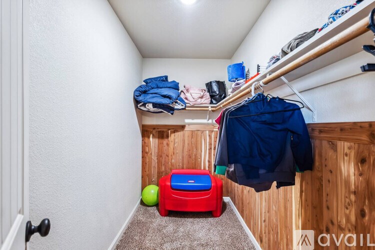 A small room with a toy truck and a ball on the floor.