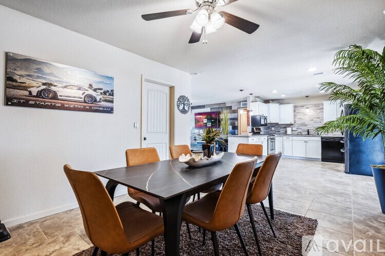 A dining room with a table and chairs.
