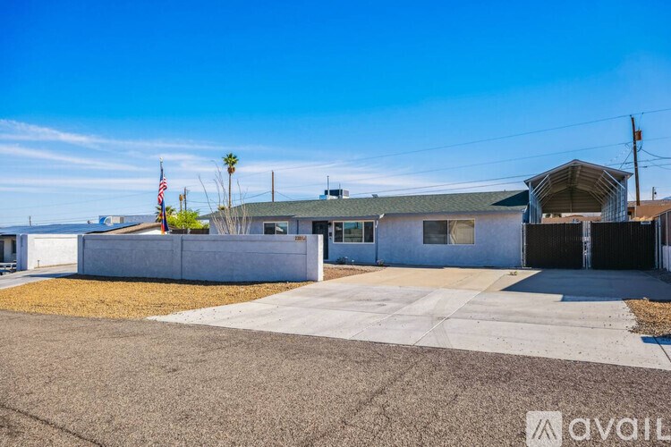 A house with a driveway and a flag on the left side.