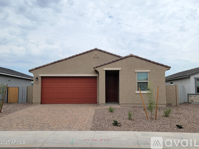 A house with a red garage door is for sale.