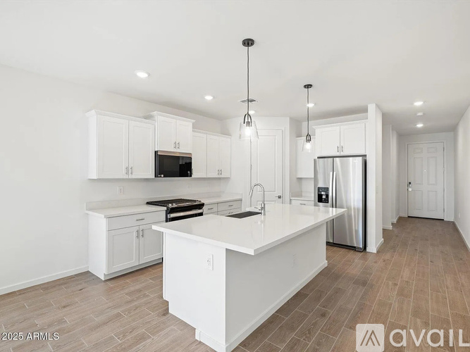 A modern kitchen with white cabinets and a central island.