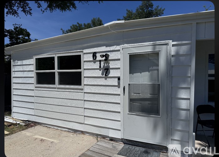 A white house with a door and windows.