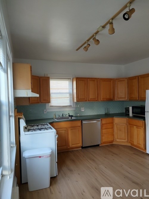 A kitchen with wooden cabinets and a white refrigerator.