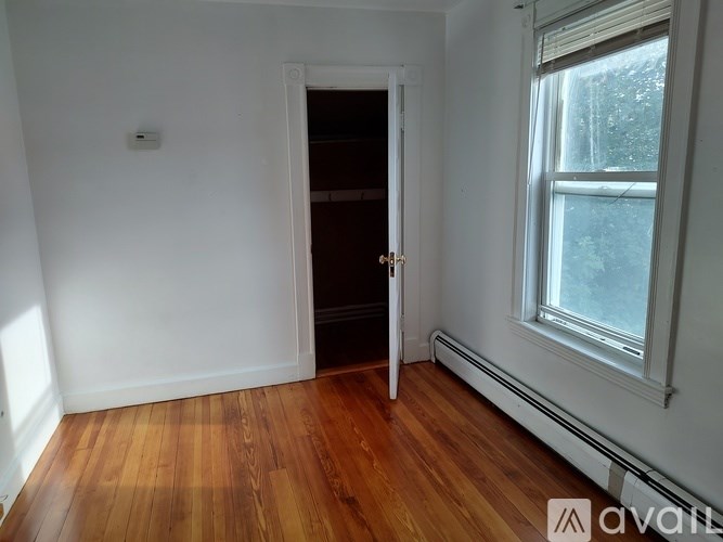A room with wooden floors and a window.