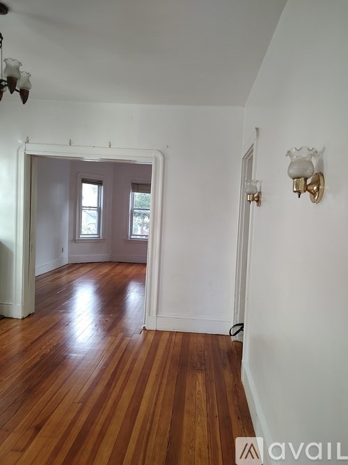A room with wooden floors and white walls.
