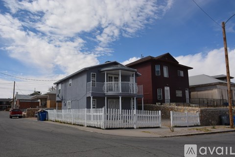 A house with a white picket fence in front of it.