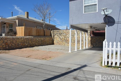 A house with a white picket fence in front of it.