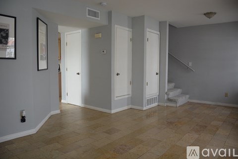 A room with a tiled floor and white walls.