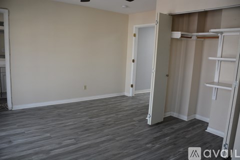 A room with a grey floor and a white door.