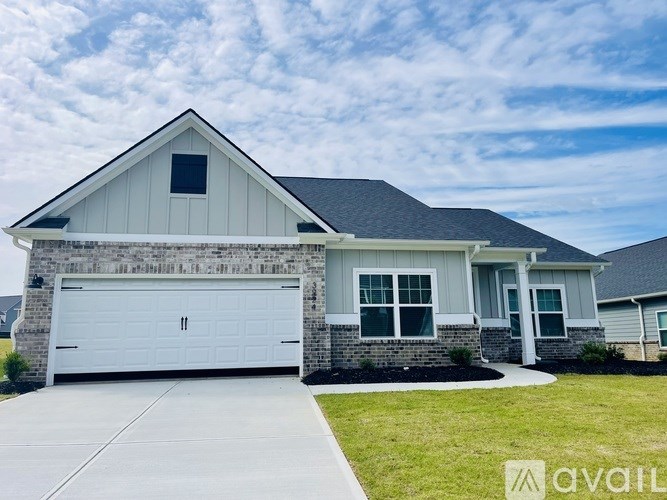 A house with a white garage door is for sale.