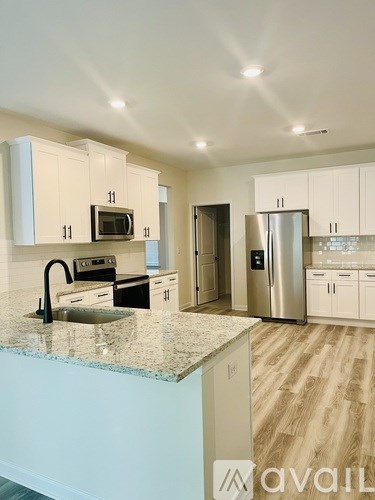 A kitchen with granite countertops and stainless steel appliances.