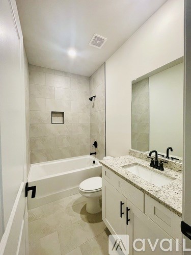 A bathroom with a white toilet and a sink.