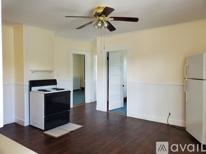 A room with a fan and a stove.