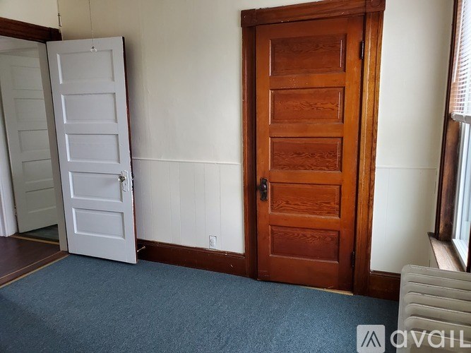 A room with a white door and a brown door.