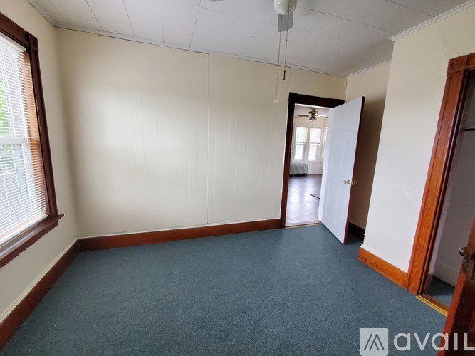 A room with a carpeted floor and white walls.