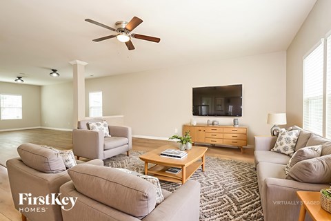 A living room with a grey couch and a wooden coffee table.