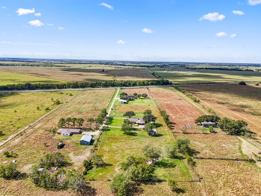 A farm with a few houses and a field.