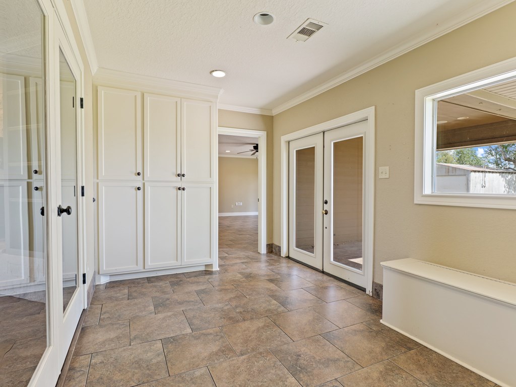 A room with a tiled floor and a window.