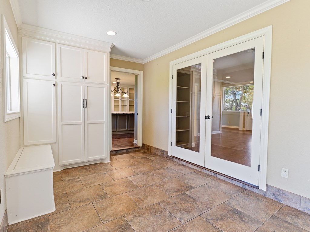 A room with a tiled floor and a fireplace.