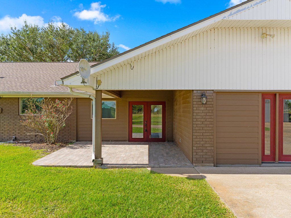 A building with a red door and a satellite dish on the roof.
