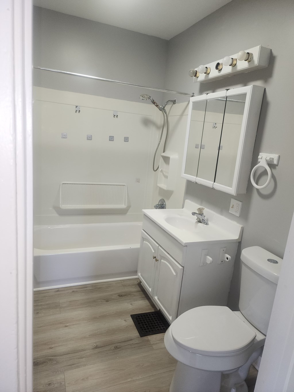 A white toilet sits next to a sink in a bathroom.