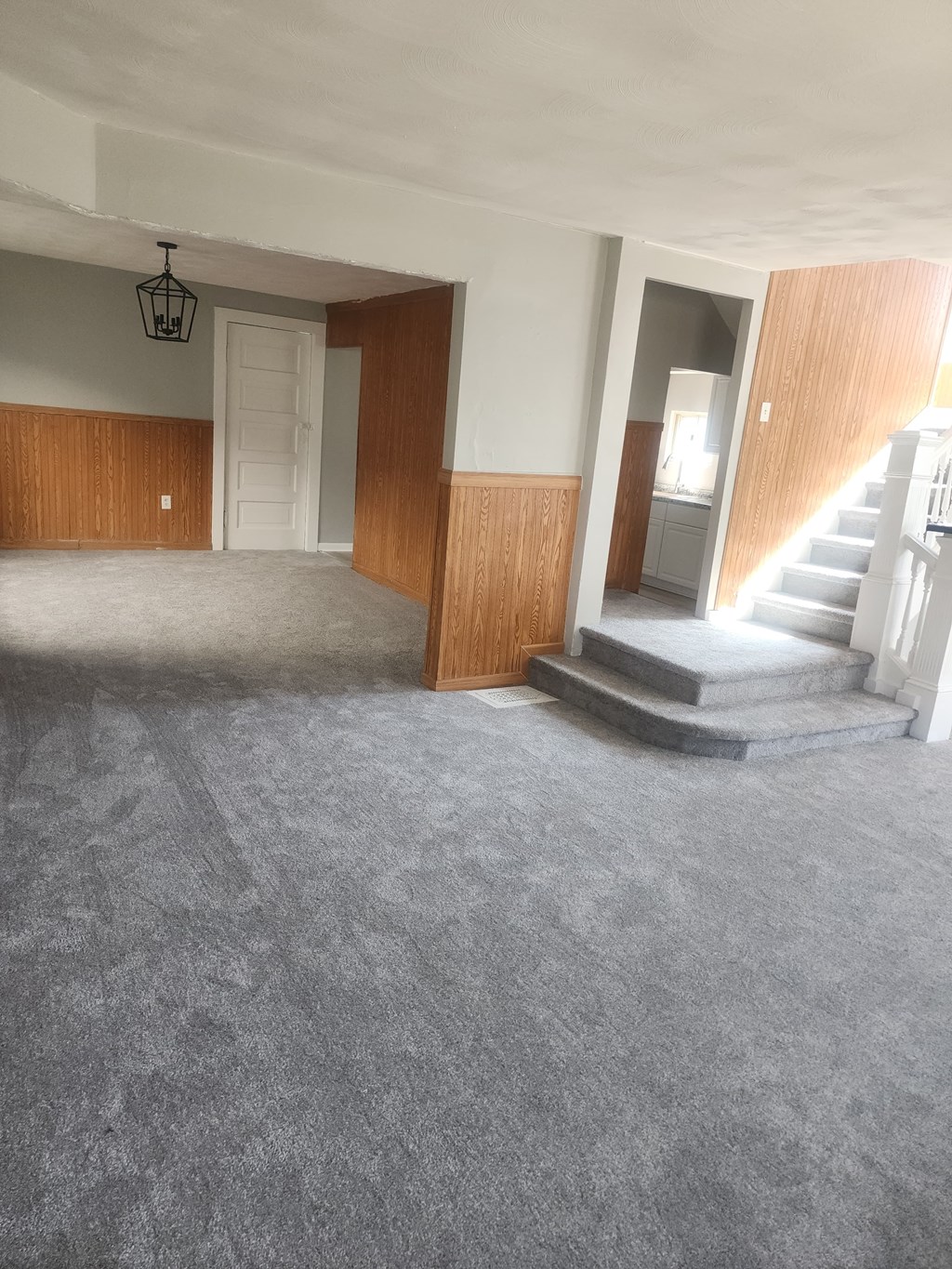 A room with a staircase and a door.