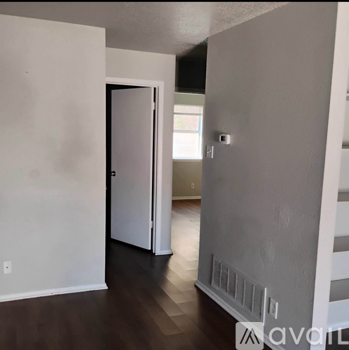 A room with a white door and a window.
