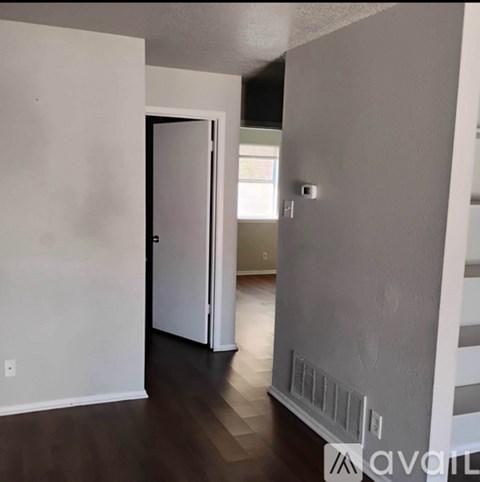 A room with a white door and a window.