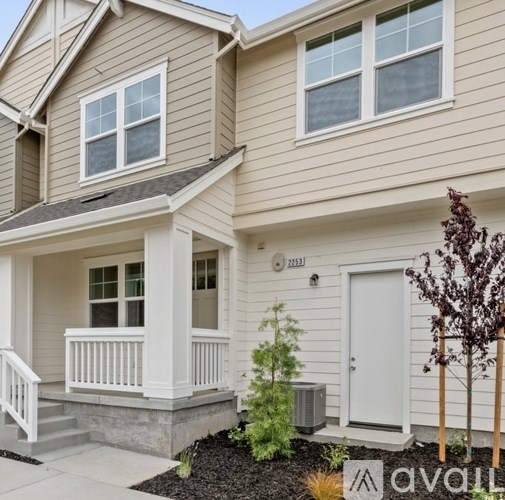 A house with a white door and windows is for sale.