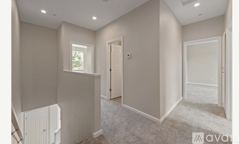 A room with a carpeted floor and a window.
