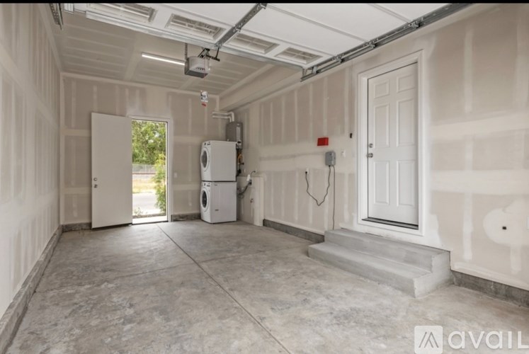A spacious garage with a washer and dryer inside.