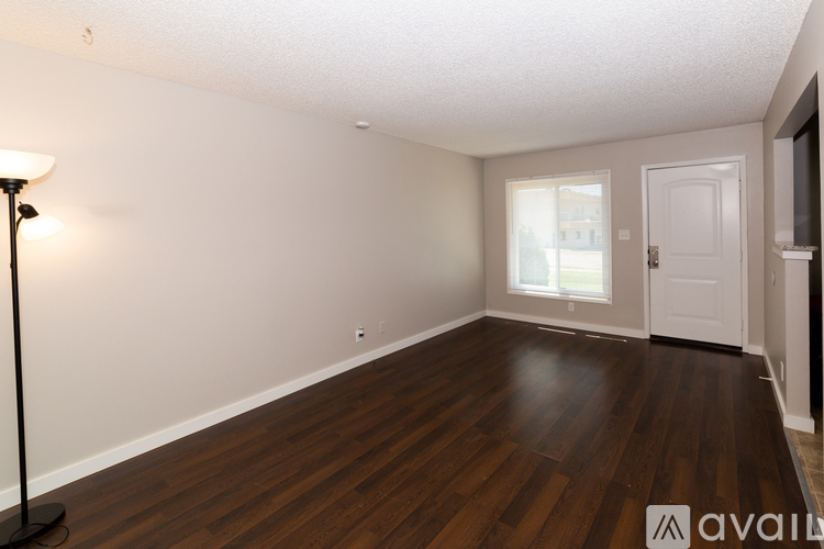 A room with wooden floors and white walls.