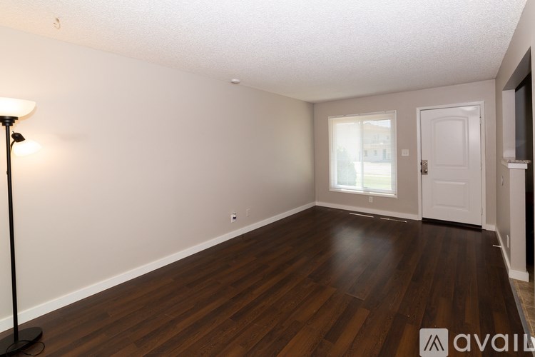 A room with wooden floors and white walls.